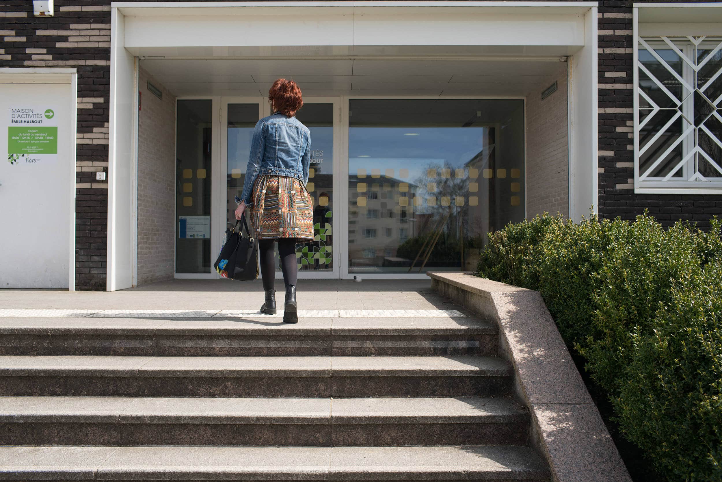 Montant les quelques marches extérieures de la maison d'activités Émile-Halbout
